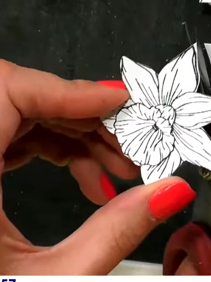 Step 6: Mat the centrally stamped floral piece onto a piece of the black patterned paper with spots and stripes, ensur