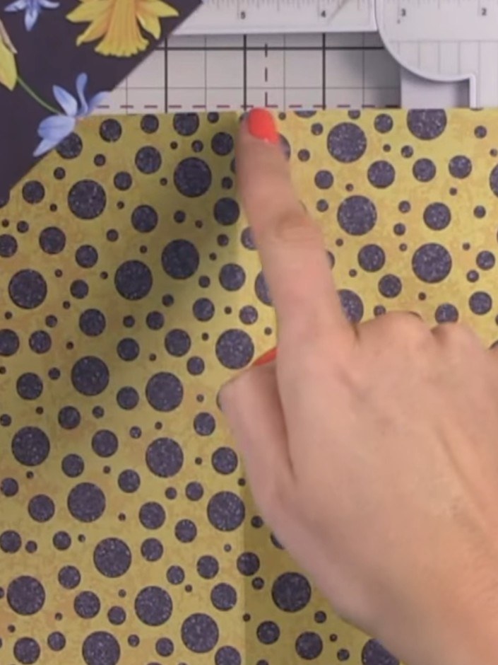 Step 3: Create a score line at one side of the yellow polka dot paper at 3.75 inches. Turn the paper around and score 