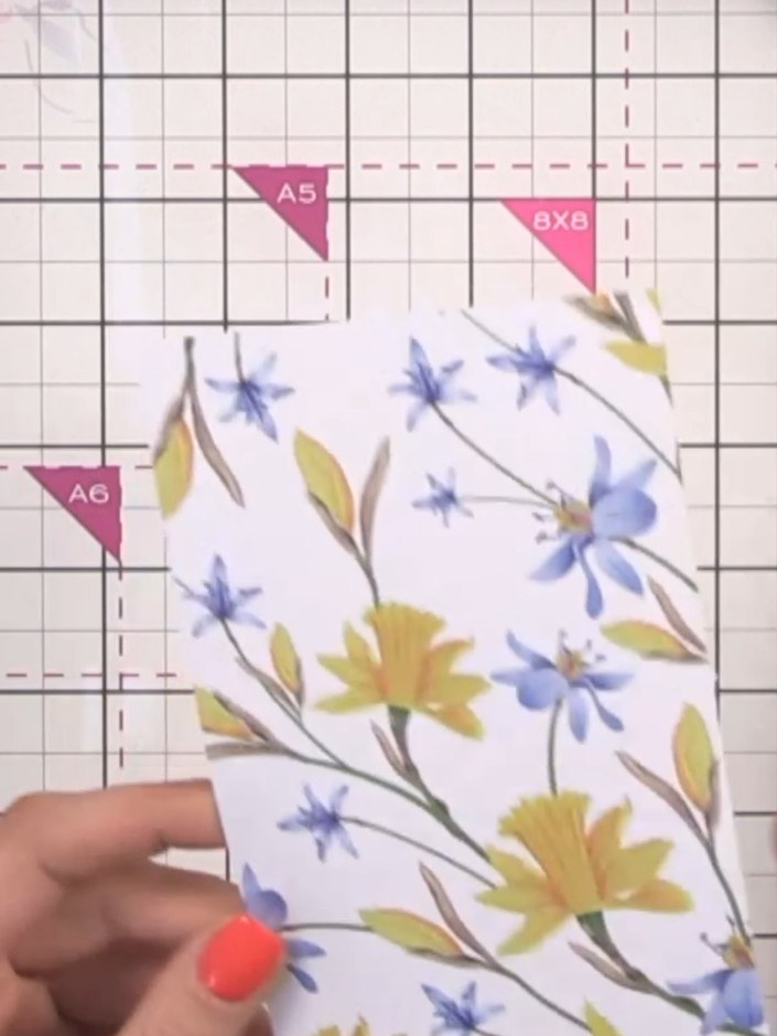 Step 4: Cut two pieces of 8 by 8 inch patterned paper in half at the 4-inch mark to create four pieces for your inner 