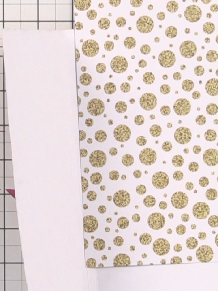 Step 7: Cut a piece of 8 by 8 inch paper in half at 4 inches for your inner pages. Then trim half an inch off the long