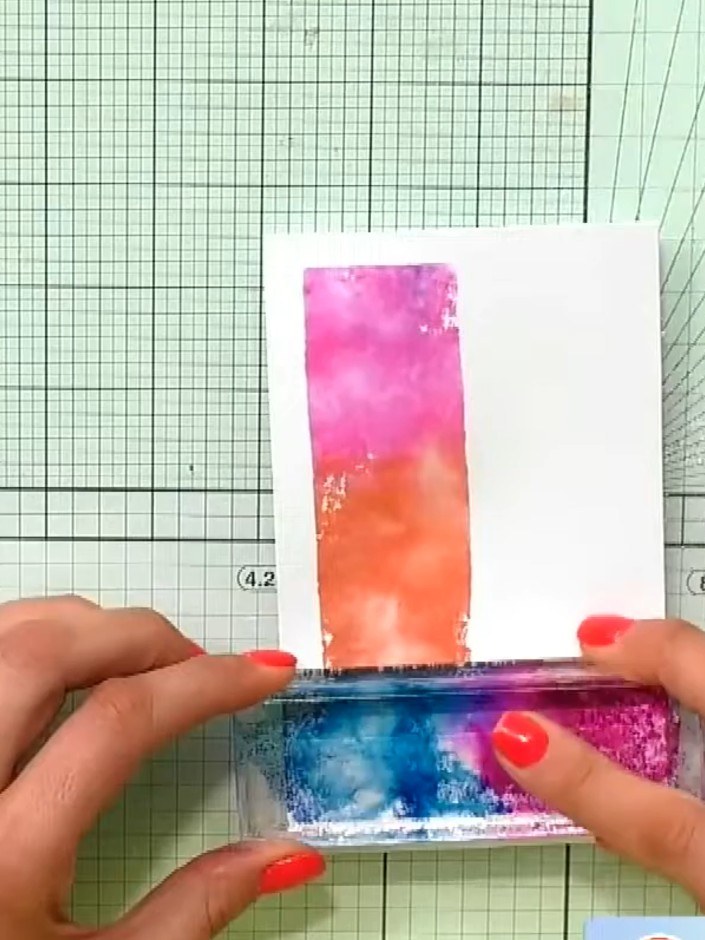 Step 3: Press your white card stock onto the inked acrylic block to transfer the ombre watercolour effect. Ensure even