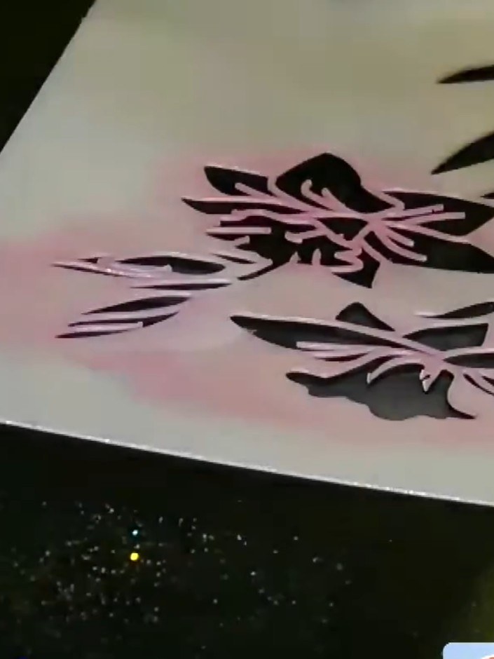 Step 1: Apply pale purple pigment ink onto black card using a brush, pouncing gently through the floral stencil. Work 