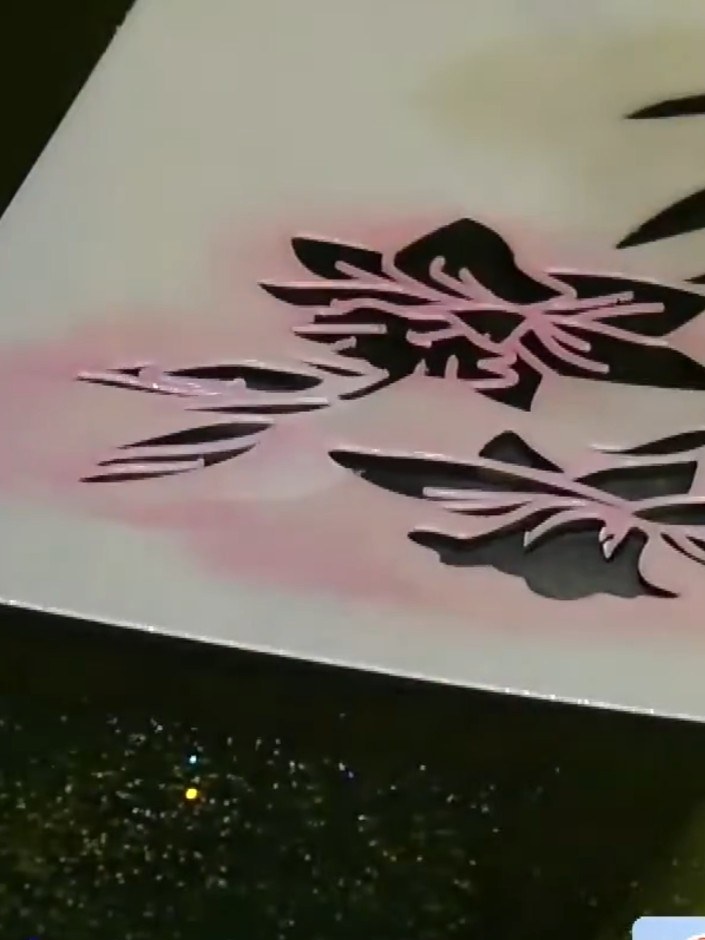 Step 2: Layer pink pigment ink over the top of the purple through the stencil, blending the colours together where the