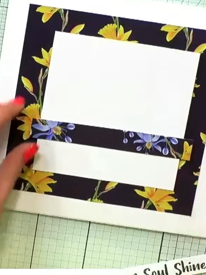 Step 3: Arrange the fussy-cut floral paper pieces around the white card panel in a circular wreath pattern. Position t