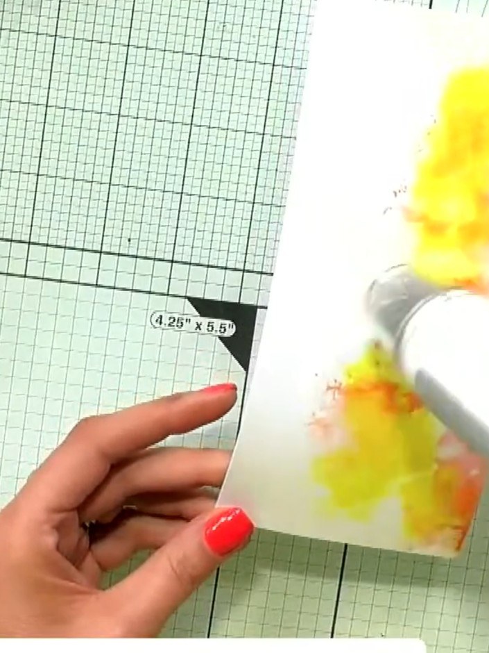 Step 5: Use a heat gun to blast the yellow and orange pigment ink on the card base, setting the colours and creating a