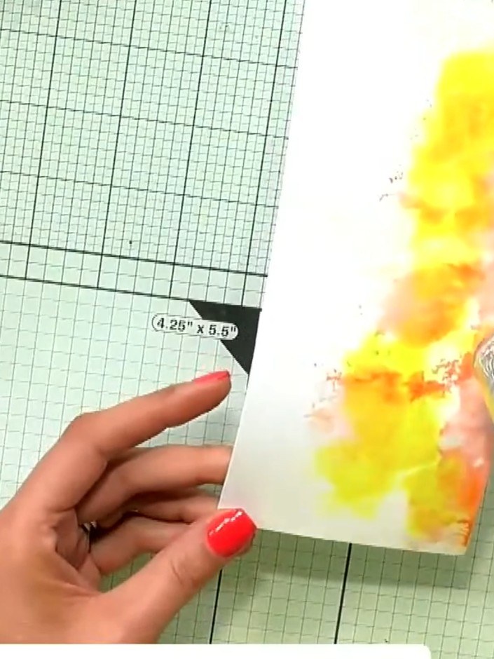 Step 6: Spray the inked card with water using a spray bottle to create watercolour texture effects. Hold the spray bot