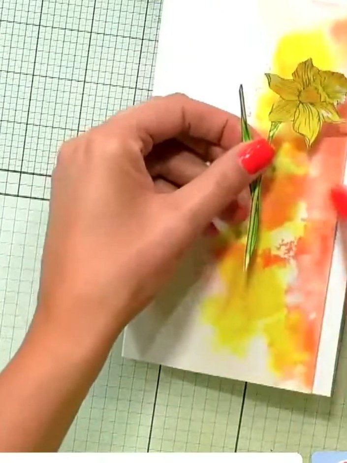 Step 7: Glue the fussy-cut daffodil stamps onto your watercolour background card, layering them to create dimension. P