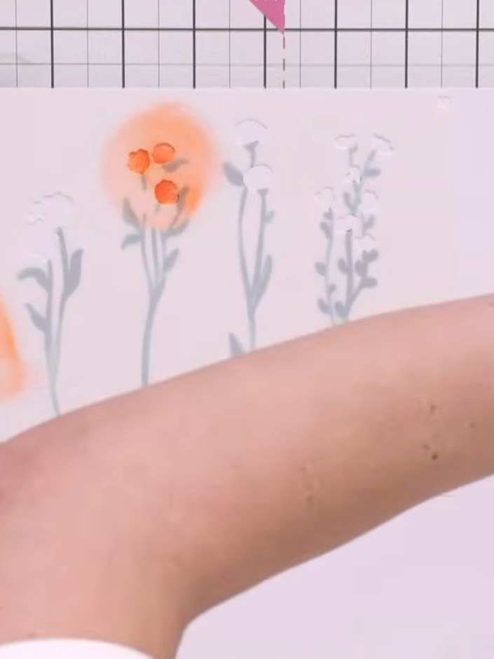 Step 3: Apply stencil number 3 using orange ink. Pounce the brush over the stencil to create flower head details with 