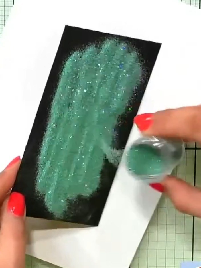 Step 3: Stamp the daffodil design onto the black card twice to ensure complete coverage and all details are clearly em