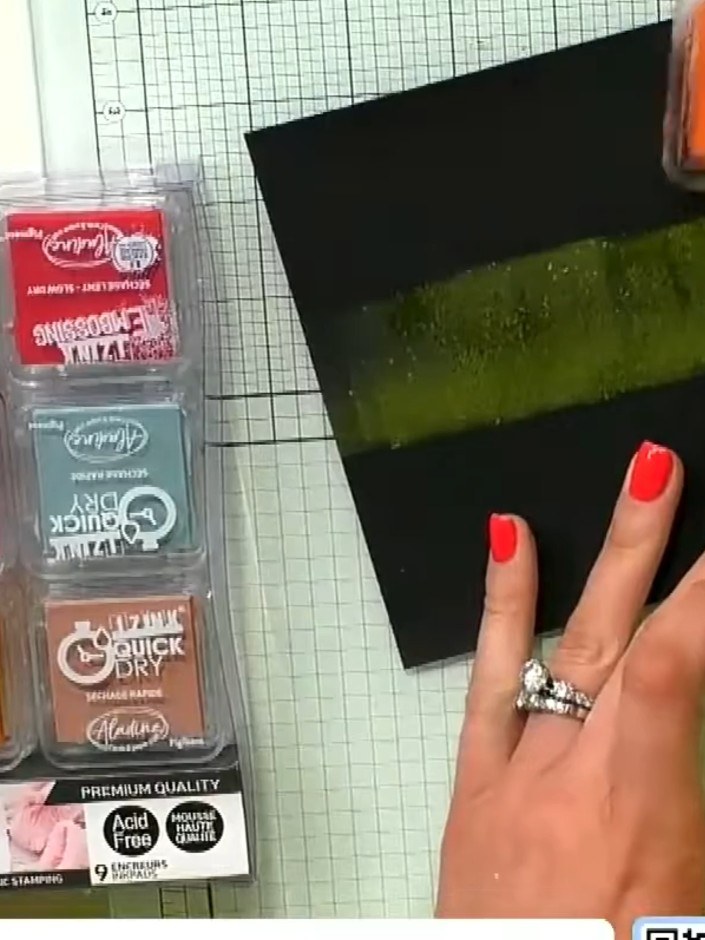 Step 2: Apply green pigment ink directly to the black card base using an ink pad. Dab and blend the ink randomly acros