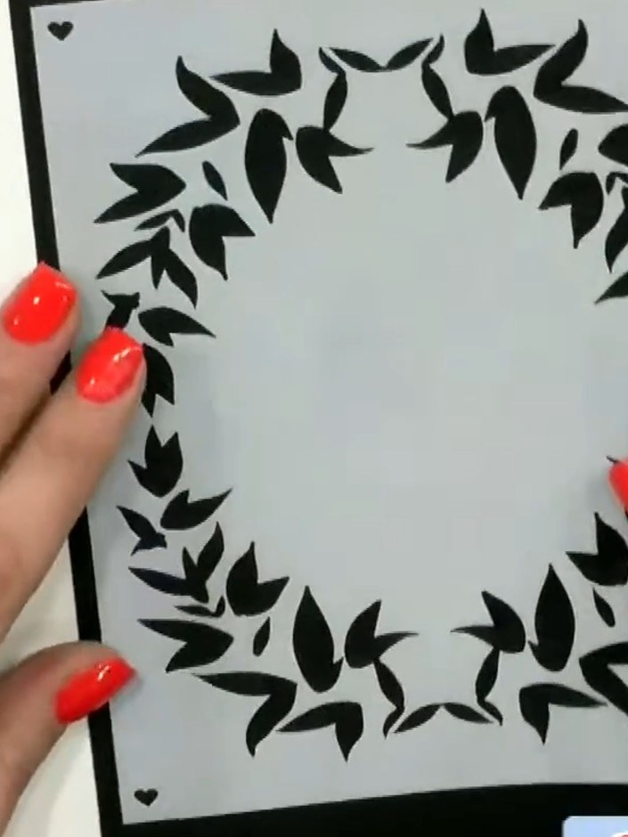 Step 1: Position stencil number 1 from the Alice set onto your black card base, placing it slightly off to one side to