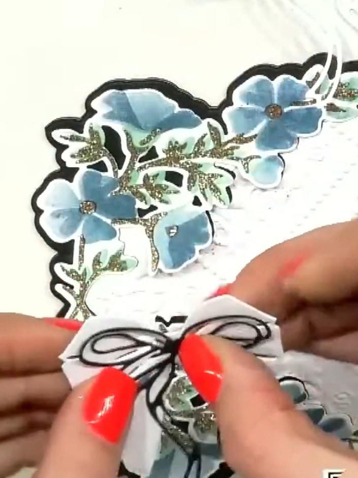 Step 5: Add additional leg pieces behind the bow by attaching extra die-cut elements to create more dimension and move