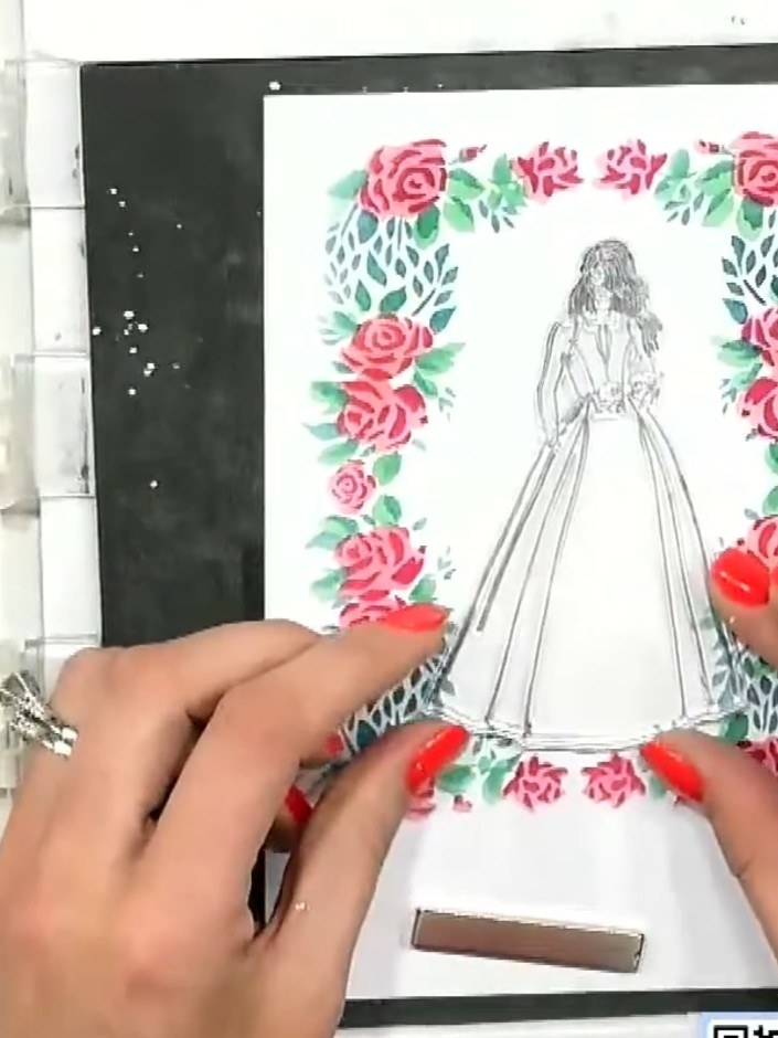 Step 6: Position and attach any additional decorative elements around the embossed dress figure. Use the floral frame 