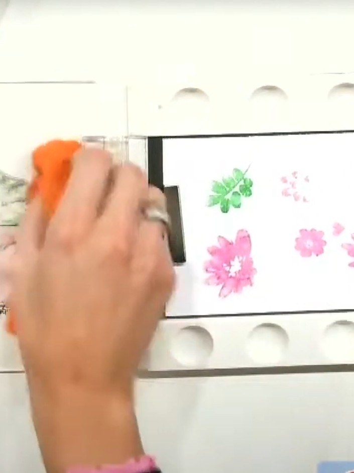 Step 2: Lightly mist the stamped watercolour floral image with water using a spray bottle to create a soft watercolour