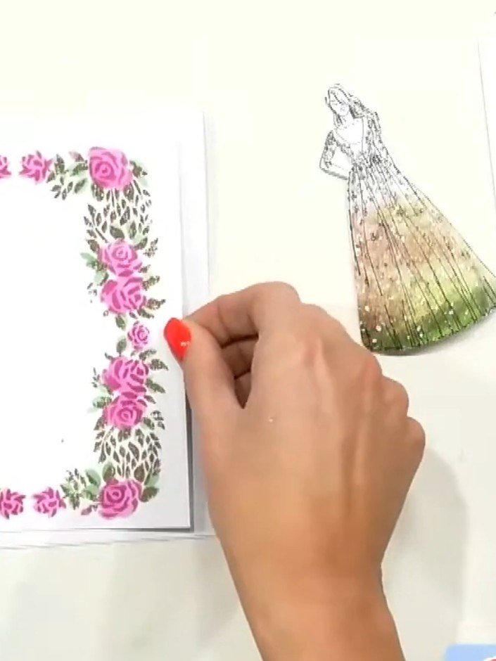 Step 6: Position the stamped floral frame over the patterned paper gown, ensuring it is centred and aligned properly. 
