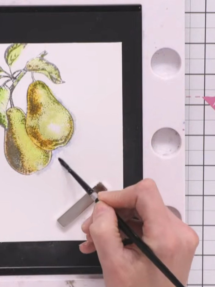 Step 8: Use a clean, damp paintbrush to blend the blue shadow outward from the pear, creating a seamless fade that giv