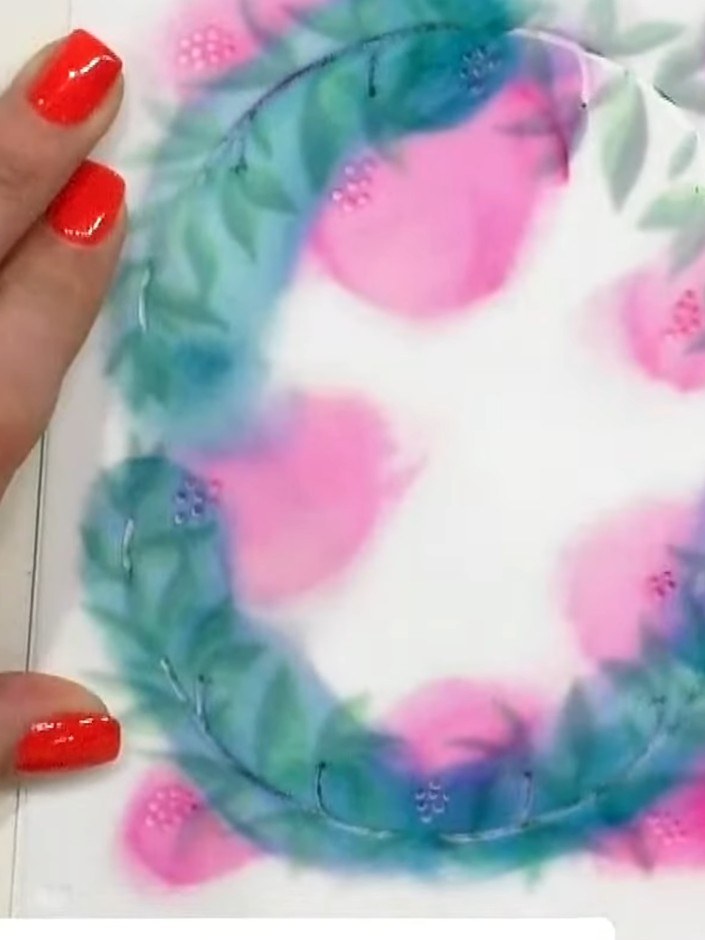 Step 11: Mount the completed floral wreath frame onto your white card base using adhesive, ensuring it is centred and s