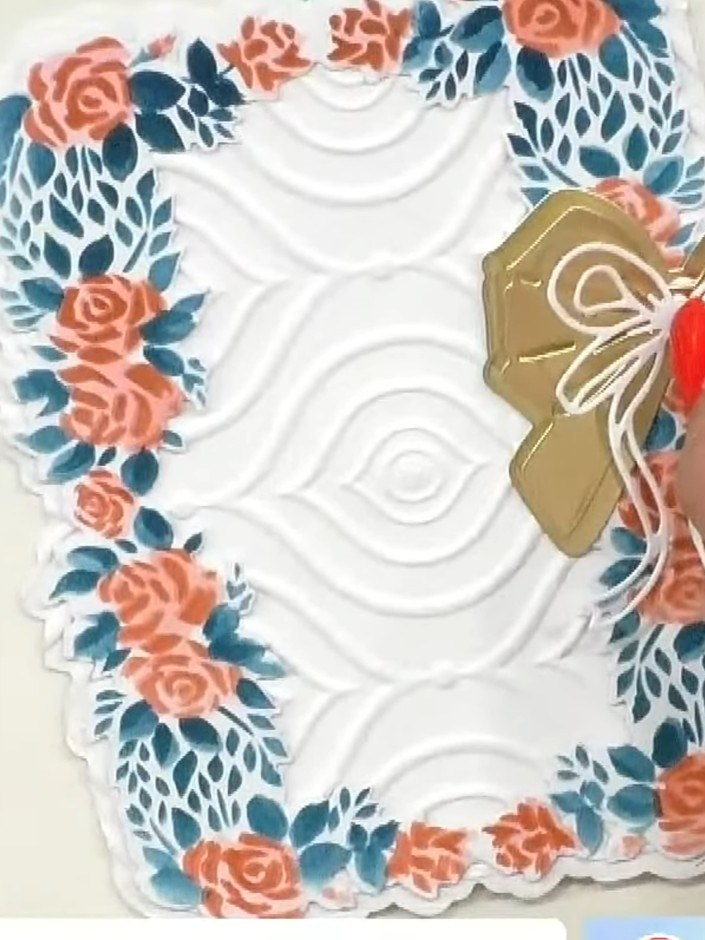 Step 10: Glue the gold cross sentiment piece onto the centre of the card. Position it so the white bow legs cascade dow