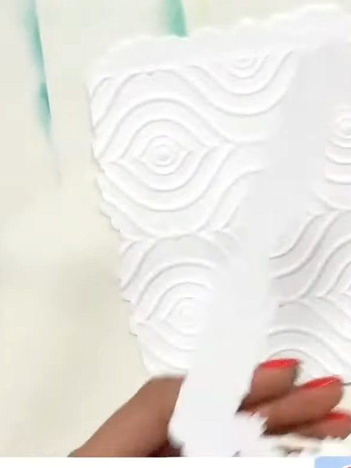 Step 7: Position the embossed frame on your card base and glue it in place, ensuring it is centred and aligned properl