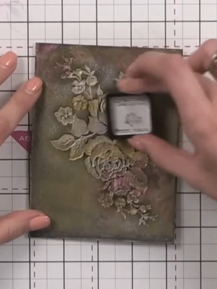Step 10: Use a cloth or tissue to burnish and blend the gold ink into the embossed floral areas. Work the gold into the