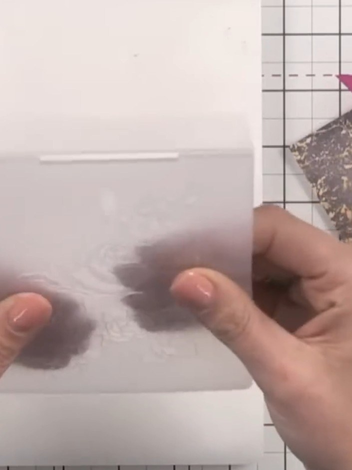 Step 3: Take a piece of patterned paper and position it inside the embossing folder on the debossed side (the recessed