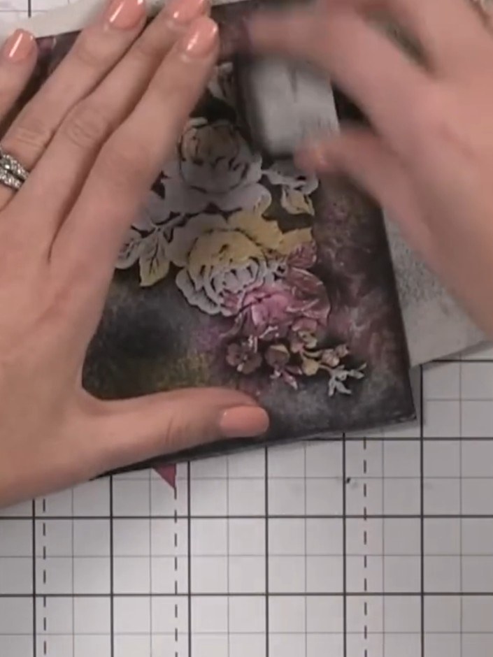 Step 7: Position the patterned paper back into the embossing folder, aligning it carefully. Hold the paper in place wi