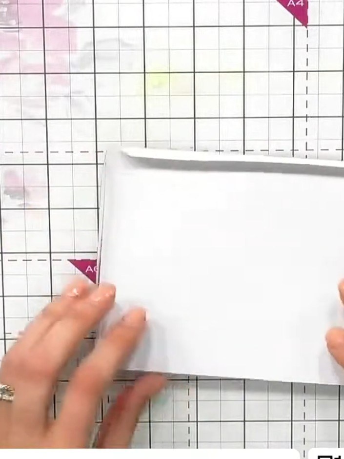 Step 4: Remove the backing tape from the second and third sides of the window frame. Fold the acetate sheet over and p