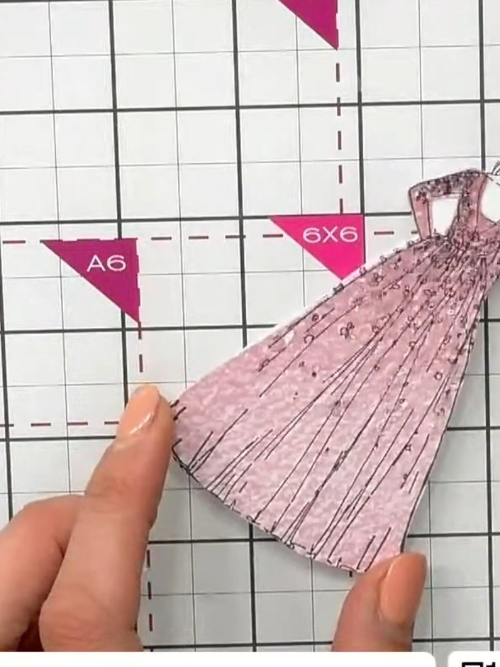 Step 4: Carefully fussy-cut around the arms and hair of the figure on the patterned pink dress piece, removing the exc