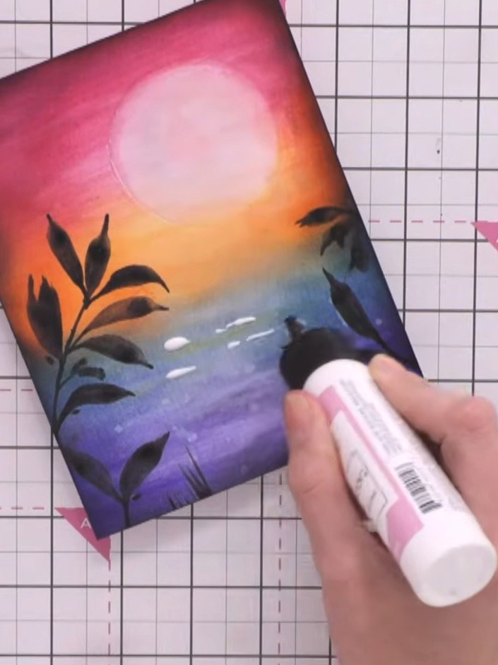 Step 12: Apply clear drying glue in vertical lines down the lower section of the card to create a water reflection. Spr