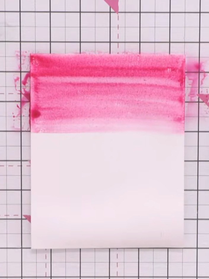Step 2: Apply red watercolour to the top of the wet card. Add orange below the red, allowing the colours to blend natu