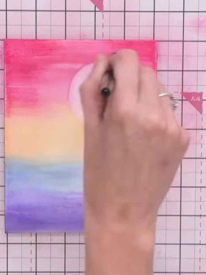 Step 7: Whilst the paper is still damp, add darker colours such as purple and blue to the top and bottom edges. Use sw