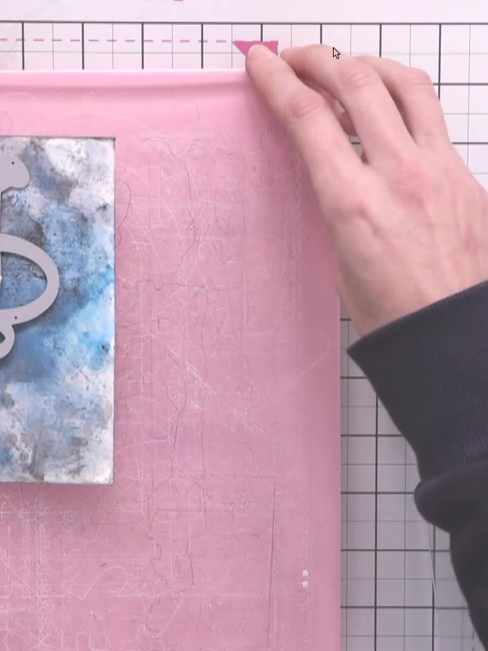 Step 10: Position the watering can die on top of the inked cardstock panel. Run the layered pieces through your die-cut