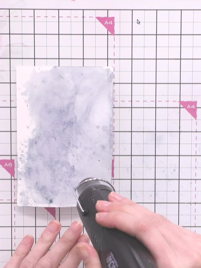 Step 4: Use a heat gun to completely dry the inked cardstock. Hold the heat gun over the surface, moving it around unt