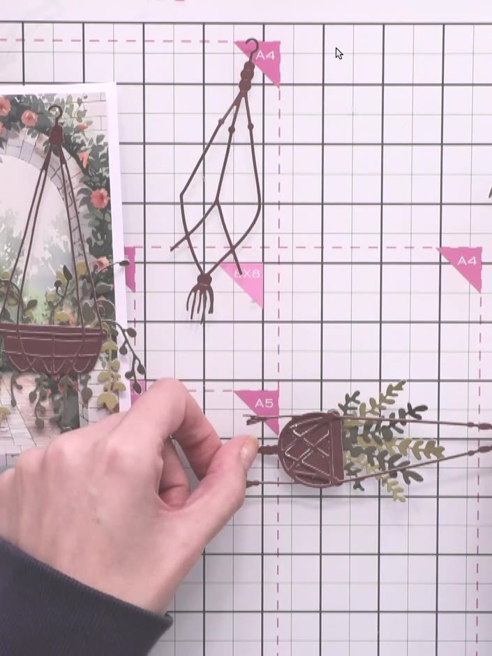 Step 3: Cut out the first hanging basket from brown cardstock. Position it on the card front with the arch slightly of