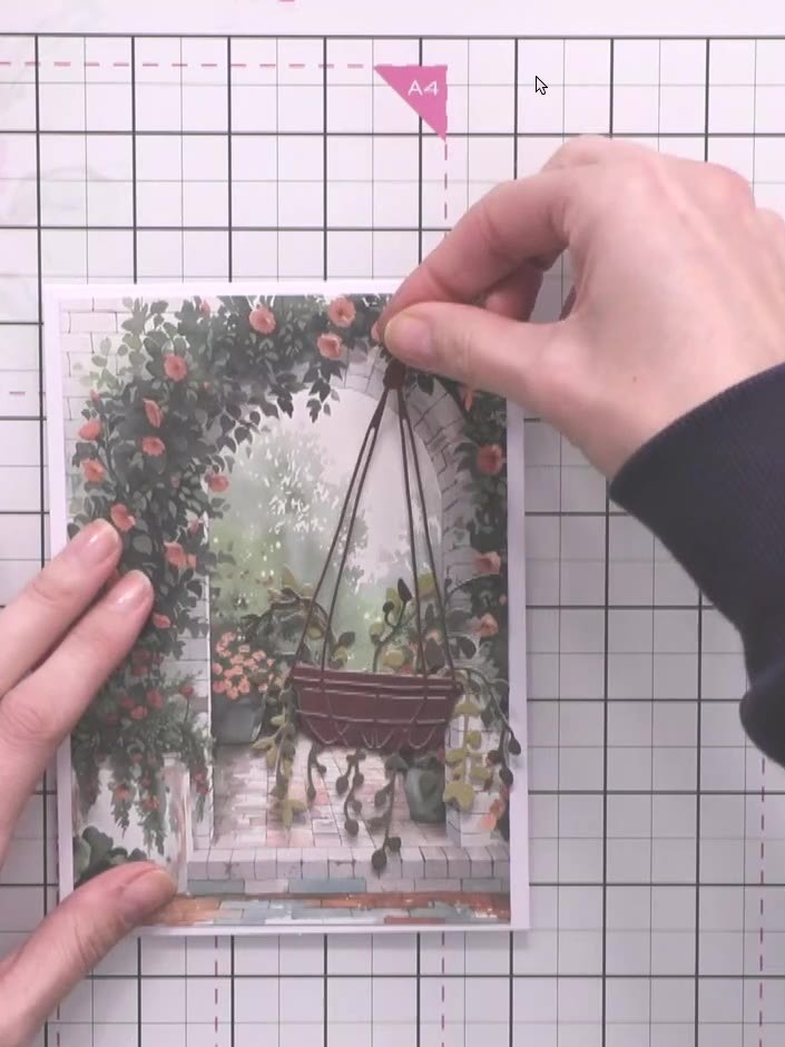 Step 4: Position the first hanging basket element on your card and glue it in place. Hold it steady whilst the glue dr
