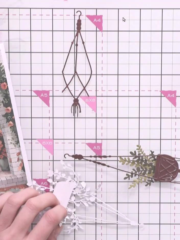 Step 7: Position the second hanging basket flat on the card front, slightly offset to one side. The basket should be p