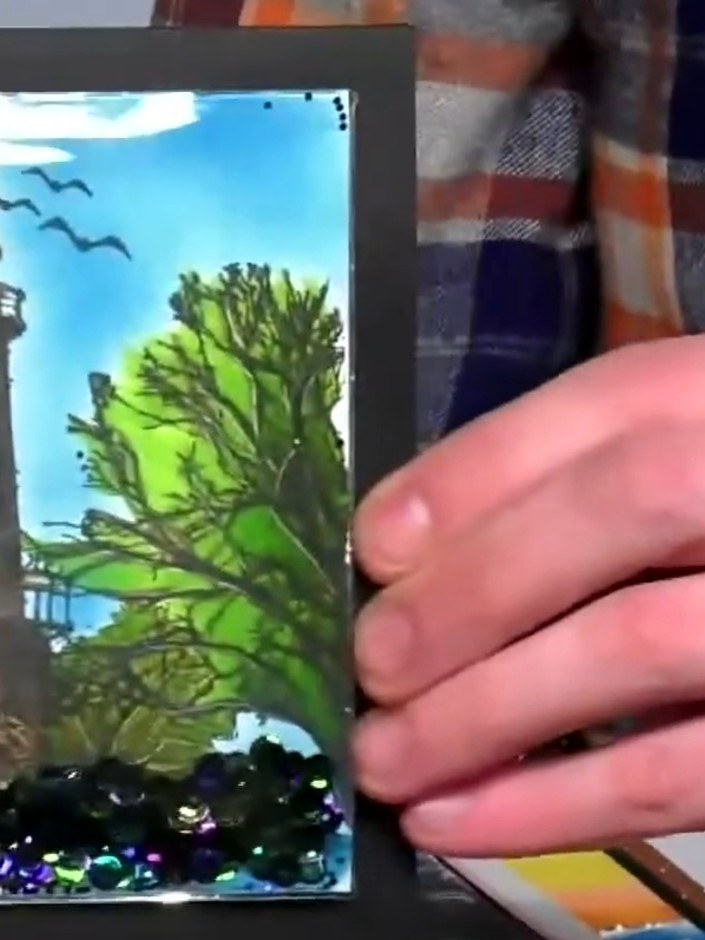 Step 3: Use a white gel pen to add fine details and highlights to the lighthouse, water, and other elements of your ca