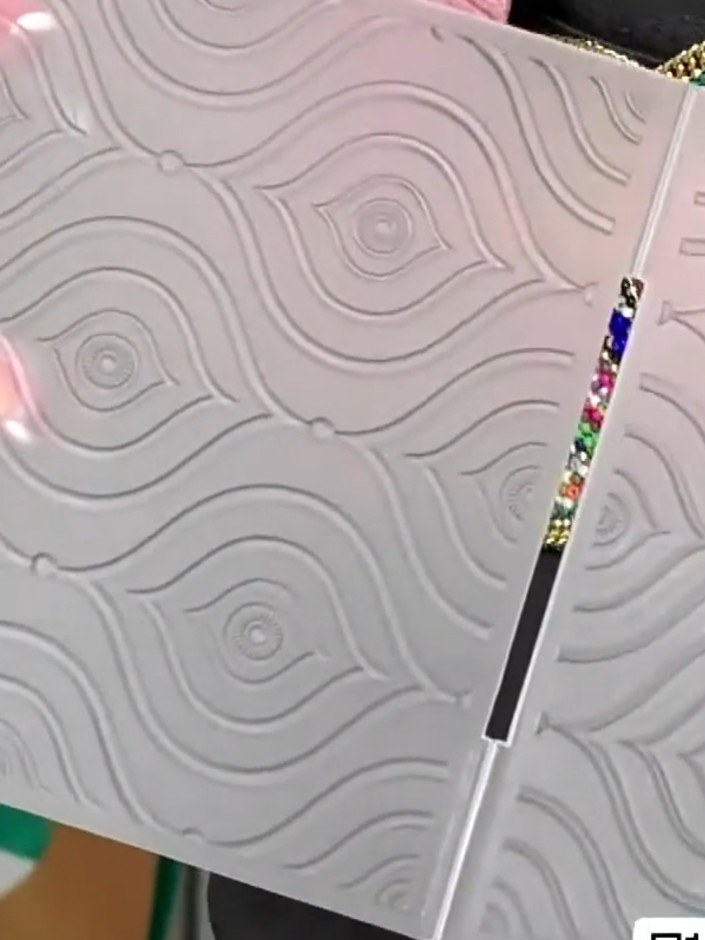 Step 2: Apply spray ink or watercolour washes to the embossed white cardstock to create an iridescent rainbow effect. 