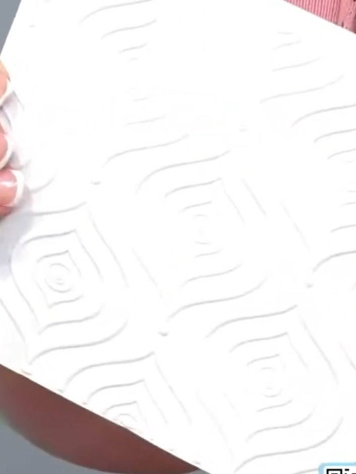 Step 5: Layer the embossed Moroccan Decor panel onto your card base using adhesive. Ensure the embossed design is cent