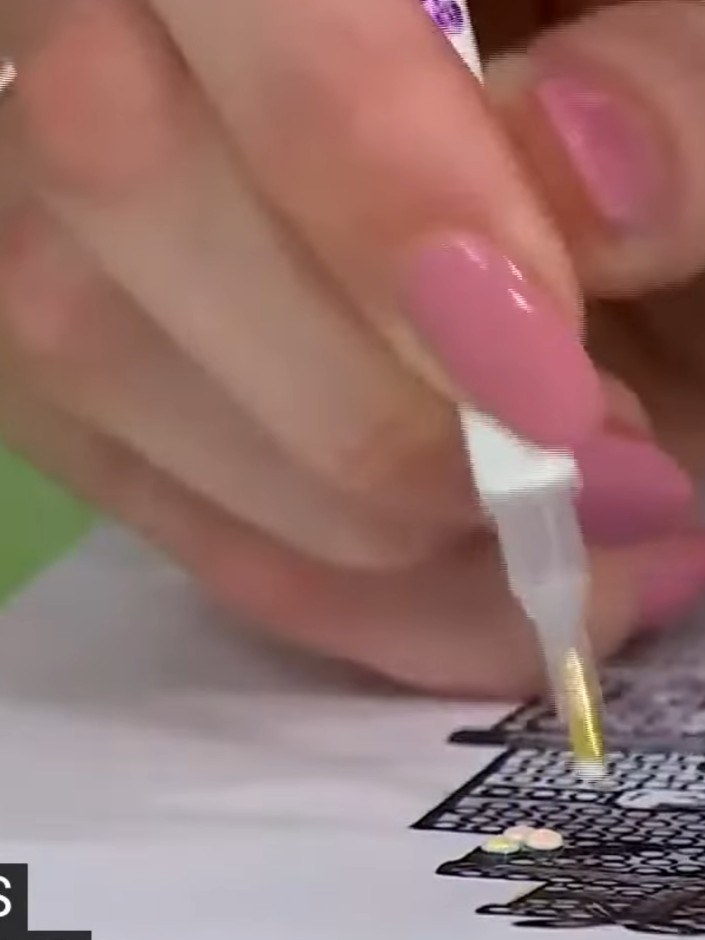 Step 6: Use the sticky pen to pick up individual crystals from the tray and place them onto the glued areas of your st