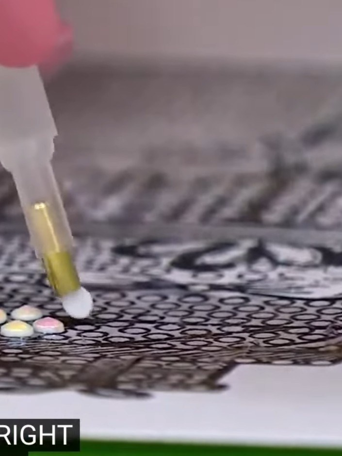 Step 8: Continue adding crystals in your chosen colours to complete the design, using the stamp's pattern as your guid