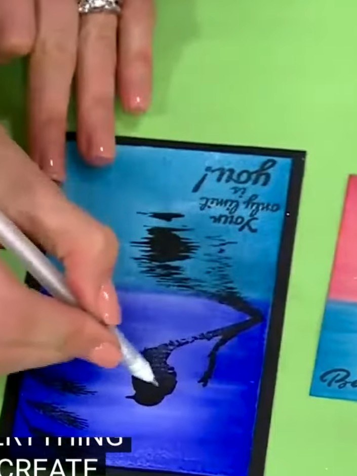 Step 2: Ink up the bird stamp and press it firmly onto your blue gradient background card, positioning the bird where 