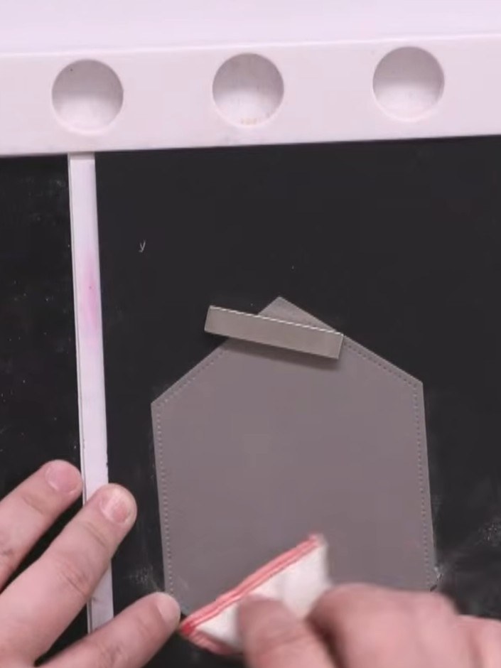 Step 1: Pre-cut a donut shape from grey card stock. Position the grey donut shape onto your black card base, ready for