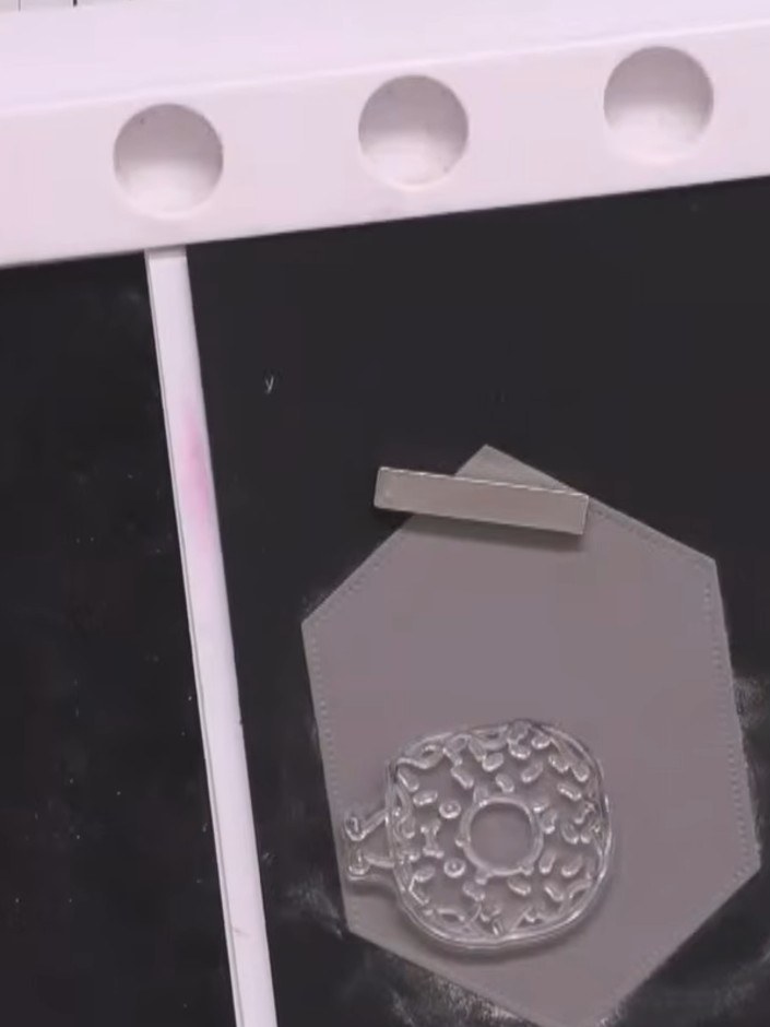 Step 2: Stamp the donut character from the Yum Chums stamp set onto the grey card using black ink. Position the stamp 
