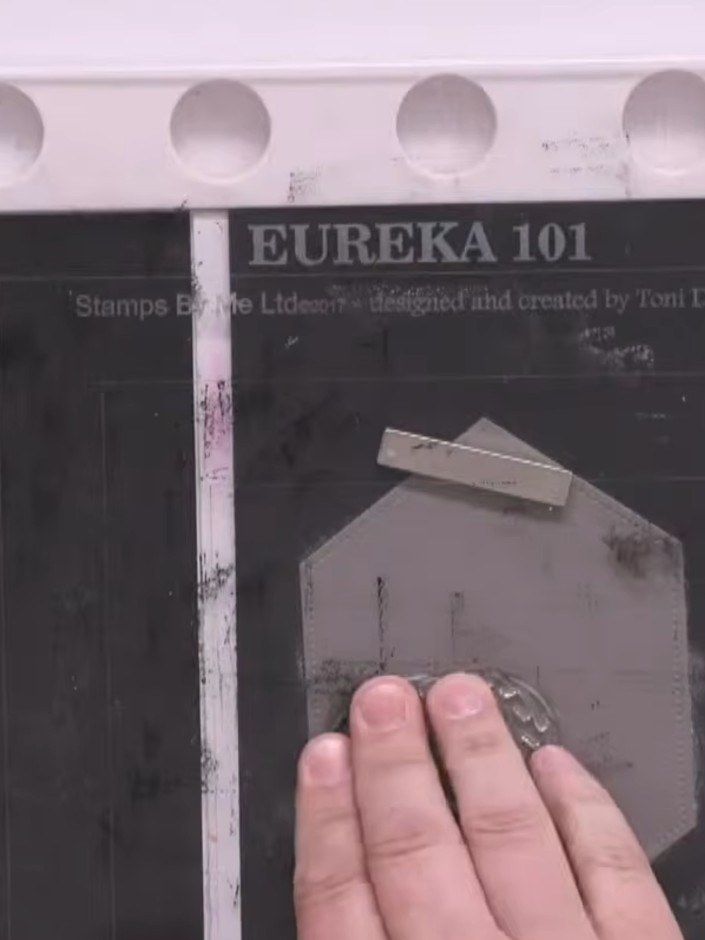 Step 3: Apply black embossing powder over the stamped image. Heat the powder with a heat tool until it melts and creat