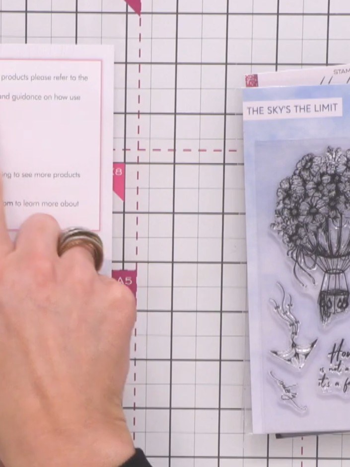 Step 1: Stamp the hot air balloon design with coordinating florals and ribbons onto your card base using black ink. Th