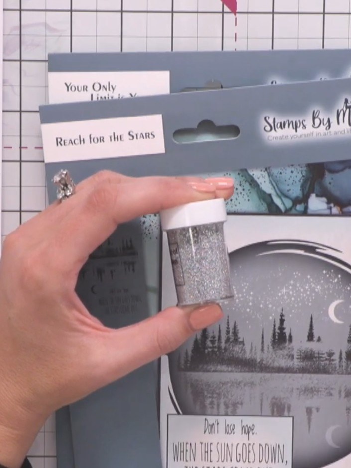 Step 4: Apply chunky glitter from the included pot to the stamped tree areas using your finger or an applicator. Gentl