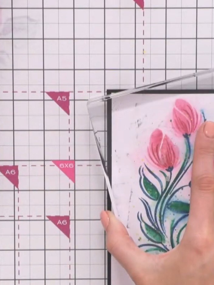 Step 5: Place a large acrylic block on top of the mounted floral design and press down firmly to ensure it adheres smo