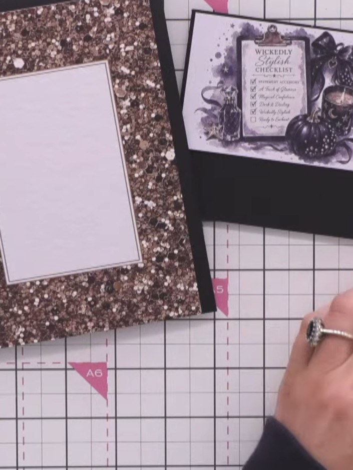 Step 4: Cut a thin strip of gold glitter card to use as a breaker panel. Position the two toppers onto the black card 