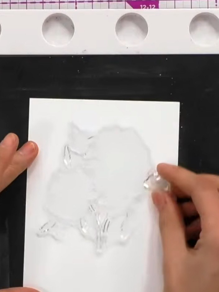 Step 1: Ink the solid portion of the lamination stamp with multiple colours using distress ink pads. Apply pink, orang